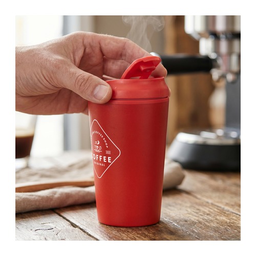 Custom Coffee Cup, 350ml Double Wall Steel with Flip Lid 6 A hand opening the lid of a branded red coffee cup beside an espresso machine, Singapore