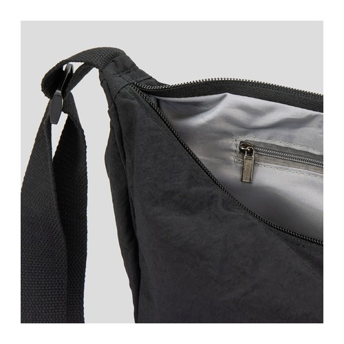 Open view of the lined interior and internal zip pocket of a crescent crossbody bag, Singapore