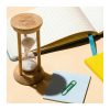 Print mock-up showing a logo laser engraved on the bamboo cap of a five minute sand timer on a desk, Singapore