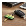 Moulded PVC key topper on a door key resting on a desk beside a car key, wallet and phone, Singapore
