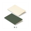 Two A5 soft cover notebooks in GRS certified recycled paper, one cream and one forest green, Singapore